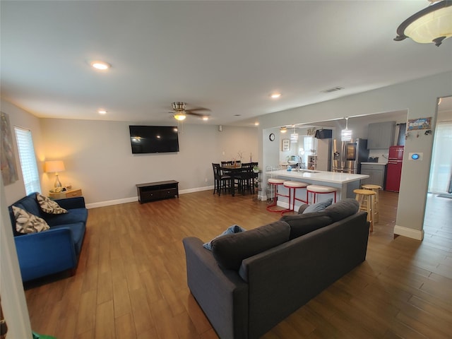 9711 Ebb St, Houston, TX 77089 - living area featuring dark wood-style flooring, a ceiling fan, baseboards, and recessed lighting