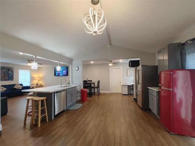 9711 Ebb St, Houston, TX 77089 - kitchen featuring stainless steel appliances, a sink, dark wood finished floors, light countertops, and open floor plan