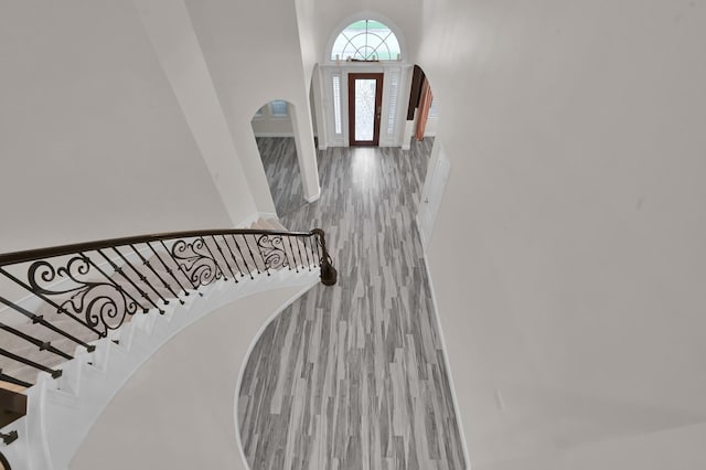28315 Hollow Springs Ln, Spring, TX 77386 - entrance foyer with arched walkways, wood finished floors, and stairway