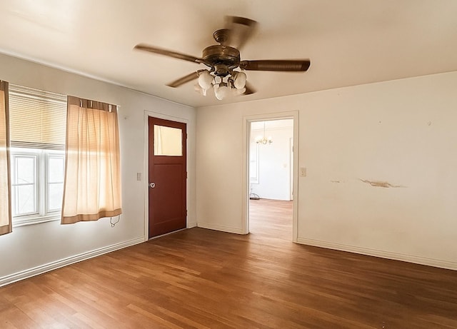 1002 Neiser Ln, Weimar, TX 78962 - foyer entrance with wood finished floors, healthy amount of natural light, a ceiling fan, and baseboards