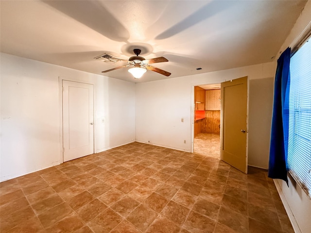 1002 Neiser Ln, Weimar, TX 78962 - unfurnished bedroom featuring a ceiling fan, ensuite bath, and stone finish floors