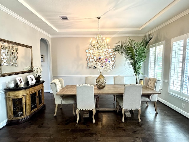 9723 Reston Ranch Ct, Cypress, TX 77433 - dining space featuring a raised ceiling, plenty of natural light, arched walkways, hardwood / wood-style floors, and crown molding