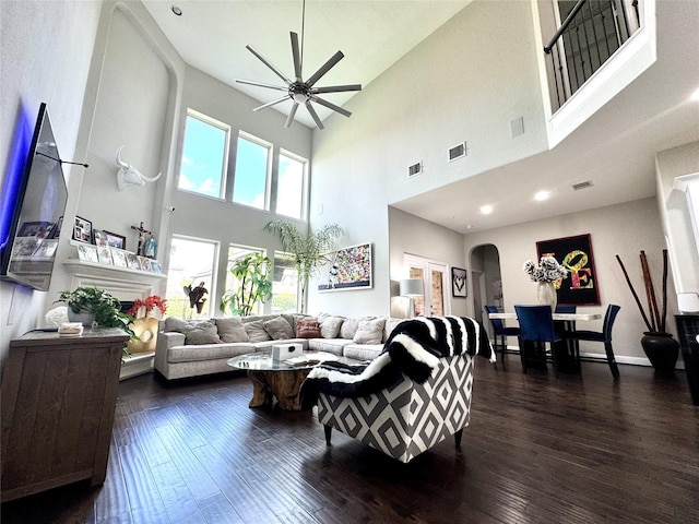 9723 Reston Ranch Ct, Cypress, TX 77433 - living room with a ceiling fan, a towering ceiling, arched walkways, and dark wood finished floors