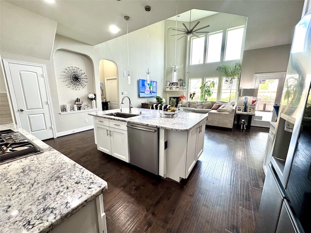 9723 Reston Ranch Ct, Cypress, TX 77433 - kitchen with appliances with stainless steel finishes, a sink, a ceiling fan, arched walkways, and light stone countertops