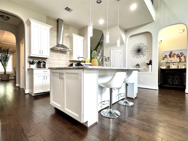 9723 Reston Ranch Ct, Cypress, TX 77433 - kitchen featuring wall chimney exhaust hood, white cabinetry, dark wood finished floors, and backsplash