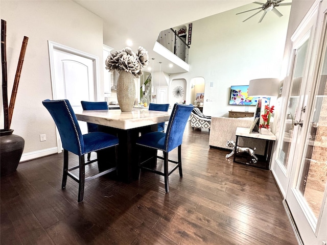 9723 Reston Ranch Ct, Cypress, TX 77433 - dining area with ceiling fan, dark wood-style flooring, arched walkways, and baseboards