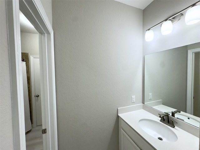 9723 Reston Ranch Ct, Cypress, TX 77433 - bathroom with vanity and a textured wall
