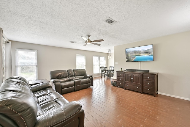 17202 Heritage Bay Dr, Webster, TX 77598 - living room featuring ceiling fan, baseboards, a textured ceiling, and wood finished floors