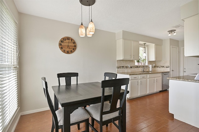 17202 Heritage Bay Dr, Webster, TX 77598 - dining room featuring dark wood finished floors and baseboards