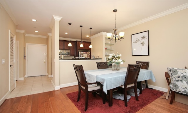 2203 Dorrington St Unit 208, Houston, TX 77030 - dining area featuring a chandelier, light wood finished floors, crown molding, baseboards, and recessed lighting