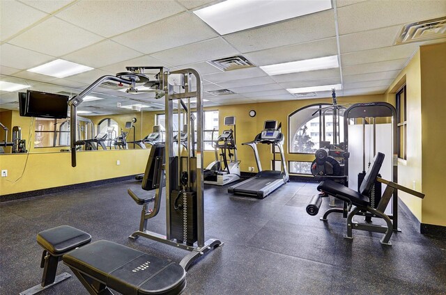 2203 Dorrington St Unit 208, Houston, TX 77030 - workout area featuring a drop ceiling, healthy amount of natural light, and baseboards