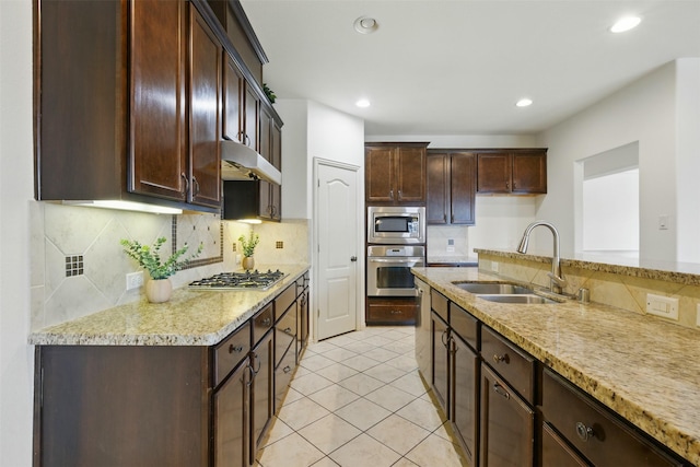 19014 Ridge Cove Ln, Cypress, TX 77433 - kitchen featuring stainless steel appliances, a sink, under cabinet range hood, backsplash, and dark brown cabinets