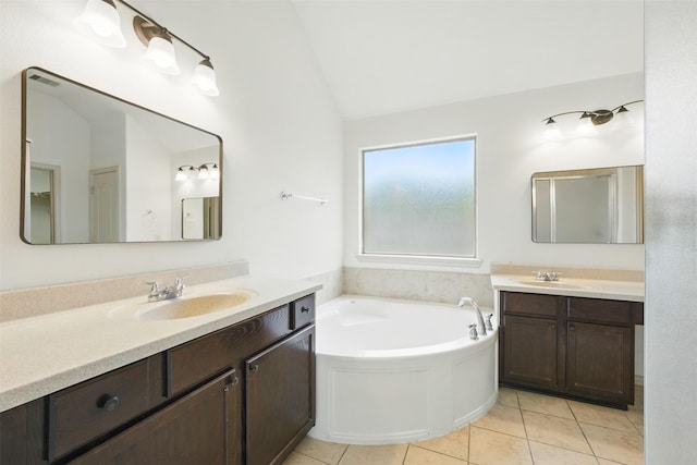 19014 Ridge Cove Ln, Cypress, TX 77433 - full bathroom featuring lofted ceiling, two vanities, a bath, and tile patterned floors