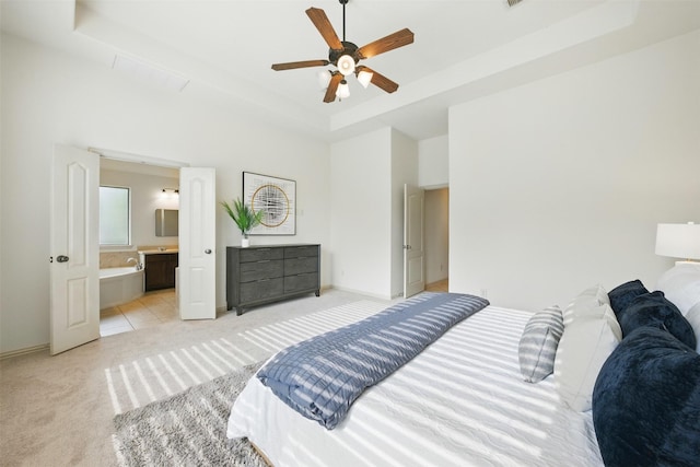 19014 Ridge Cove Ln, Cypress, TX 77433 - bedroom featuring light colored carpet, a raised ceiling, connected bathroom, baseboards, and ceiling fan