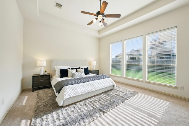 19014 Ridge Cove Ln, Cypress, TX 77433 - carpeted bedroom featuring a tray ceiling, baseboards, and a ceiling fan