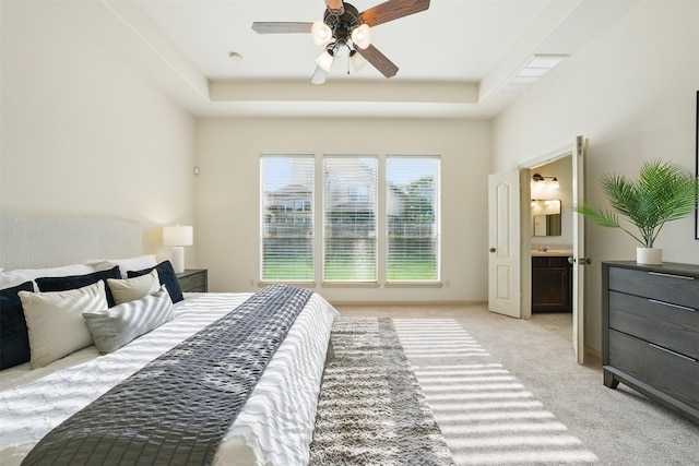 19014 Ridge Cove Ln, Cypress, TX 77433 - bedroom with light carpet, a raised ceiling, connected bathroom, and a ceiling fan