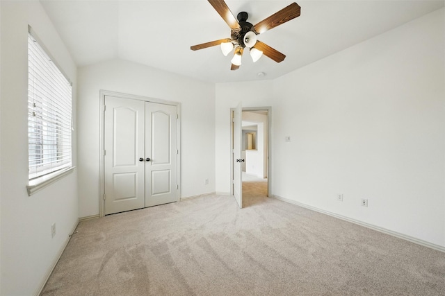 19014 Ridge Cove Ln, Cypress, TX 77433 - unfurnished bedroom featuring light colored carpet, vaulted ceiling, a closet, ceiling fan, and baseboards