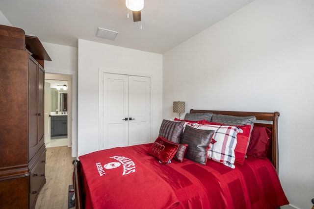 6405 Highland Pine Ln, Houston, TX 77091 - bedroom featuring wood finished floors, a sink, a closet, a ceiling fan, and ensuite bath