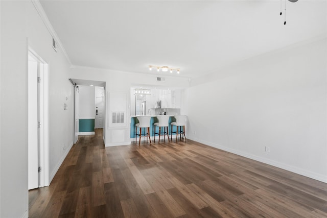 18809 Egret Bay Blvd Unit 114, Webster, TX 77058 - living area featuring dark wood finished floors, ornamental molding, and baseboards