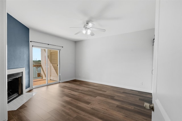 18809 Egret Bay Blvd Unit 114, Webster, TX 77058 - unfurnished living room with a ceiling fan, wood finished floors, a fireplace with flush hearth, and baseboards