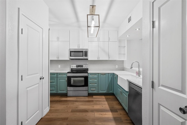 18809 Egret Bay Blvd Unit 114, Webster, TX 77058 - kitchen featuring appliances with stainless steel finishes, a sink, white cabinetry, open shelves, and light countertops