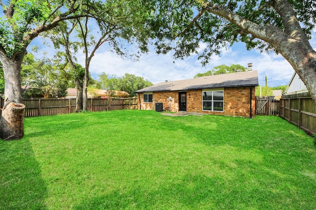 4439 Kacee Dr, Houston, TX 77084 - back of house featuring a fenced backyard, a chimney, and brick siding