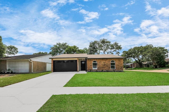 4439 Kacee Dr, Houston, TX 77084 - view of front of property featuring brick siding, concrete driveway, a front yard, and a garage