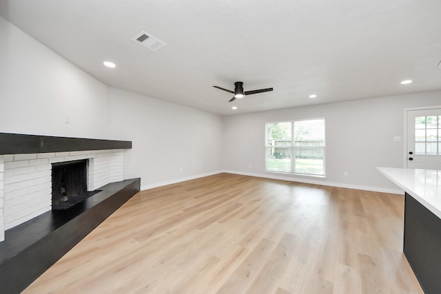 4439 Kacee Dr, Houston, TX 77084 - unfurnished living room with light wood-style floors, a fireplace, a ceiling fan, and recessed lighting