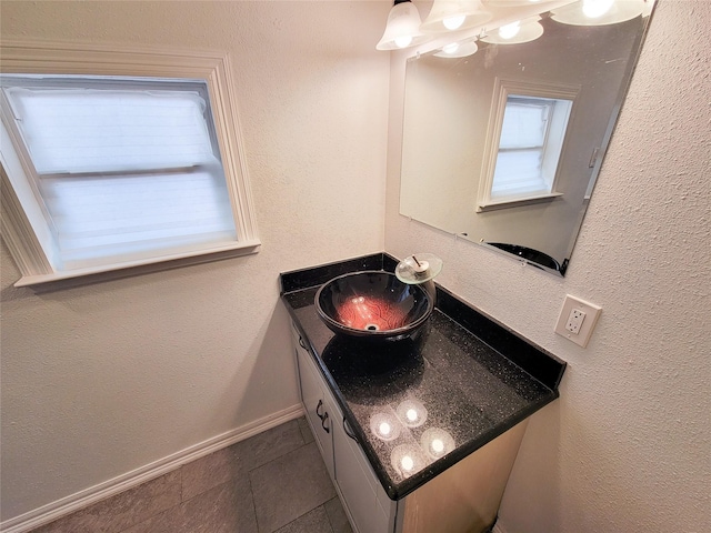 5703 Fraser Ave, Galveston, TX 77551 - bathroom featuring vanity, baseboards, and tile patterned flooring