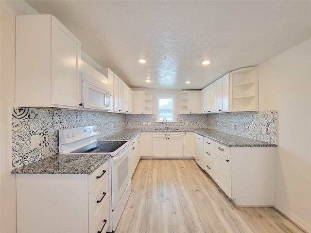 5703 Fraser Ave, Galveston, TX 77551 - kitchen featuring open shelves, white appliances, a sink, dark stone countertops, and recessed lighting