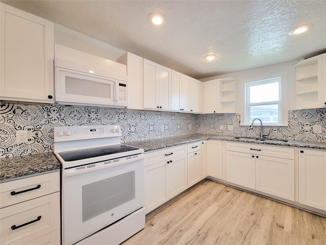 5703 Fraser Ave, Galveston, TX 77551 - kitchen featuring white appliances, open shelves, a sink, dark stone countertops, and light wood-style flooring