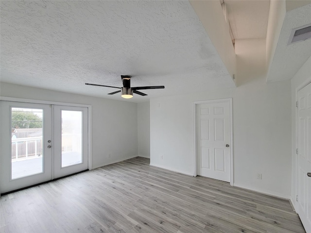 5703 Fraser Ave, Galveston, TX 77551 - spare room featuring light wood-style flooring, french doors, ceiling fan, baseboards, and a textured ceiling