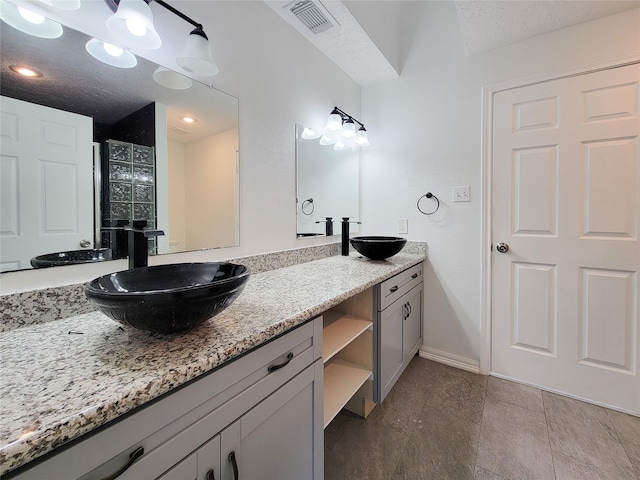 5703 Fraser Ave, Galveston, TX 77551 - full bath with double vanity and baseboards