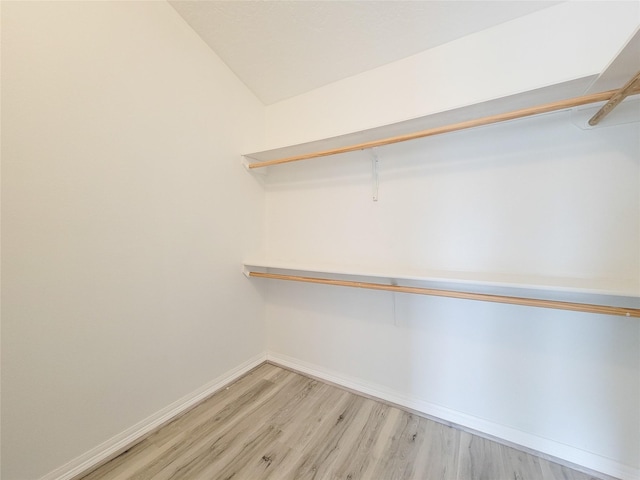 5703 Fraser Ave, Galveston, TX 77551 - spacious closet featuring wood finished floors and lofted ceiling
