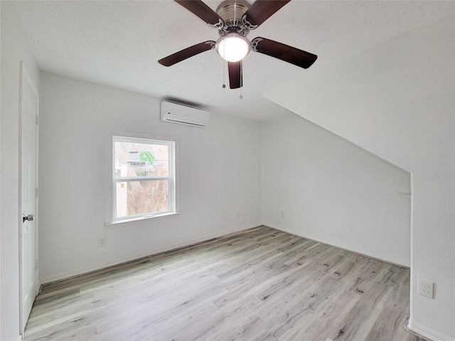 5703 Fraser Ave, Galveston, TX 77551 - additional living space featuring a wall mounted air conditioner, light wood-style floors, and a ceiling fan