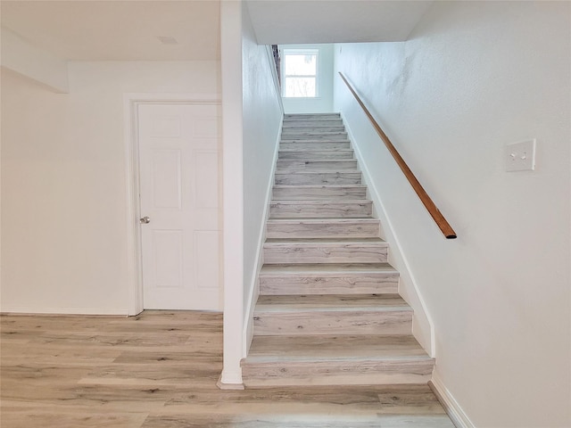 5703 Fraser Ave, Galveston, TX 77551 - staircase with wood finished floors