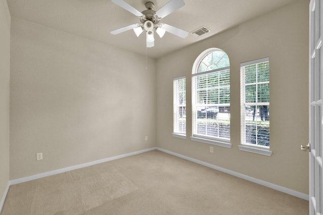 6 Caelin Ct, The Woodlands, TX 77382 - spare room featuring light carpet, baseboards, and ceiling fan