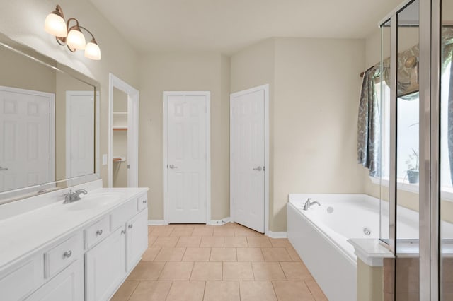 6 Caelin Ct, The Woodlands, TX 77382 - full bath featuring a closet, vanity, a bath, baseboards, and tile patterned floors