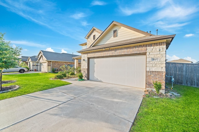5107 Twin Summit Dr, Rosenberg, TX 77469 - view of front of house with brick siding, concrete driveway, a garage, and stone siding