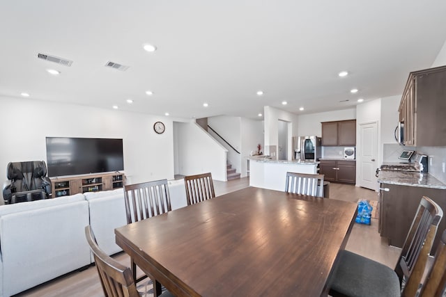 5107 Twin Summit Dr, Rosenberg, TX 77469 - dining space with recessed lighting, stairway, and light wood-style flooring