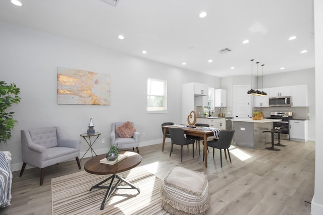2105 Sam Wilson St Unit A, Houston, TX 77020 - living room with light wood-style flooring, recessed lighting, and baseboards