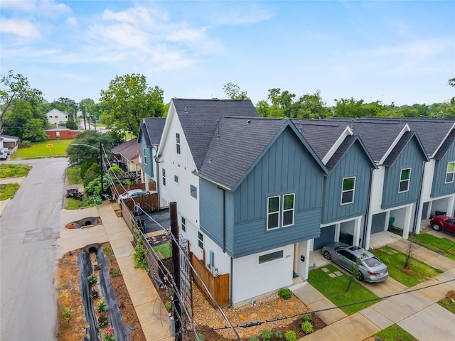 2105 Sam Wilson St Unit A, Houston, TX 77020 - view of front of property featuring board and batten siding, a shingled roof, an attached garage, and concrete driveway