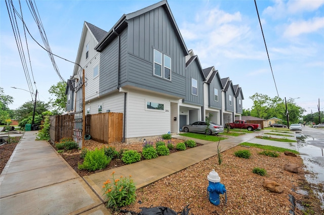 2105 Sam Wilson St Unit A, Houston, TX 77020 - view of home's exterior with board and batten siding, an attached garage, and a residential view