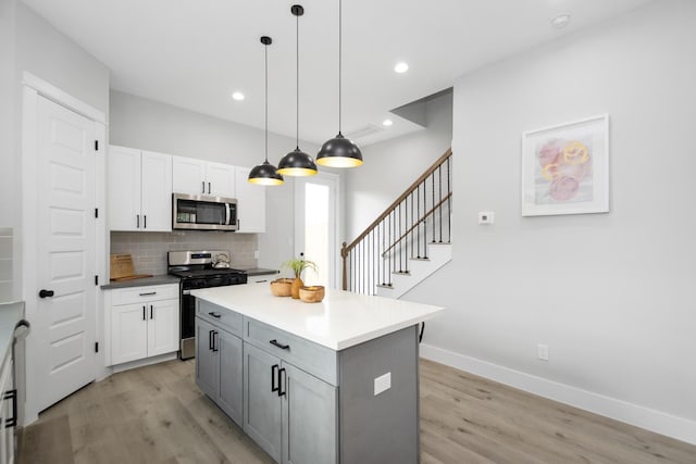 2105 Sam Wilson St Unit A, Houston, TX 77020 - kitchen featuring appliances with stainless steel finishes, light wood-style flooring, white cabinets, and recessed lighting