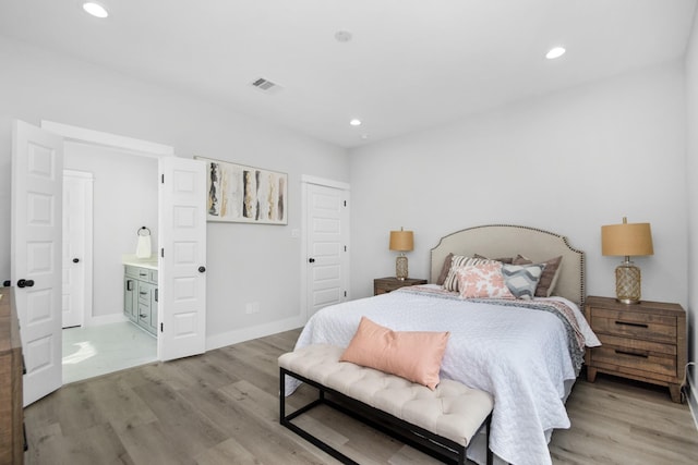 2105 Sam Wilson St Unit A, Houston, TX 77020 - bedroom with light wood-style floors, recessed lighting, baseboards, and ensuite bath