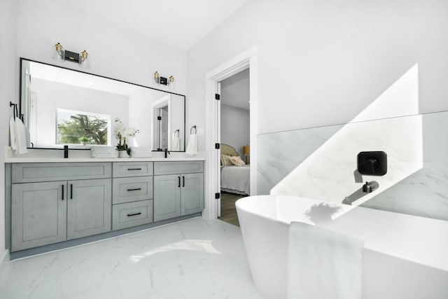2105 Sam Wilson St Unit A, Houston, TX 77020 - ensuite bathroom with marble finish flooring, double vanity, and a freestanding tub
