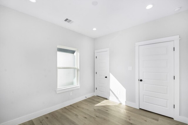 2105 Sam Wilson St Unit A, Houston, TX 77020 - unfurnished bedroom featuring light wood-style flooring, recessed lighting, and baseboards