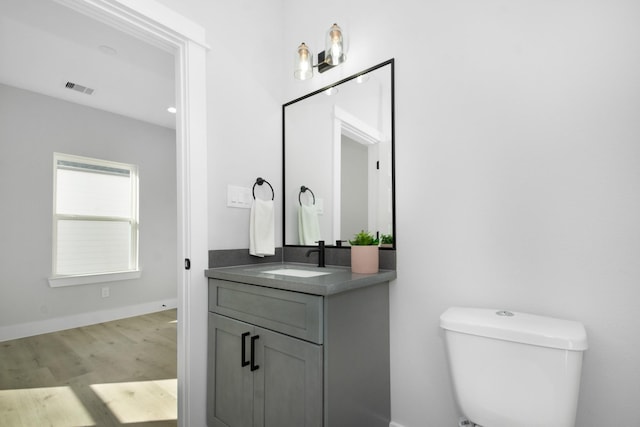 2105 Sam Wilson St Unit A, Houston, TX 77020 - bathroom with vanity, wood finished floors, toilet, and baseboards