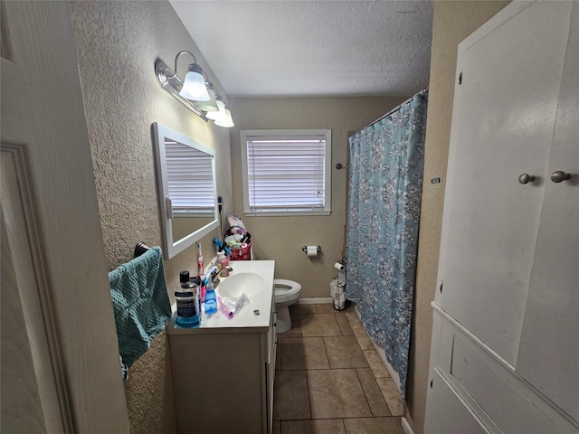 213 Linda St, Deer Park, TX 77536 - bathroom with toilet, vanity, tile patterned floors, a textured ceiling, and a textured wall