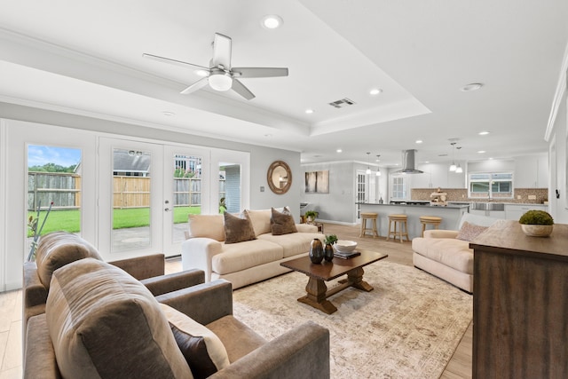 3619 N Braeswood Blvd, Houston, TX 77025 - living area with a ceiling fan, recessed lighting, a tray ceiling, light wood-type flooring, and french doors